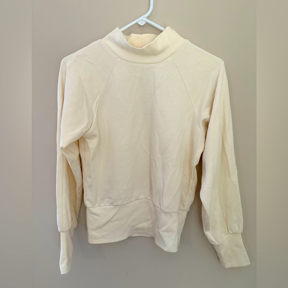 Cream colored mock turtleneck sweatshirt. No tags but never worn or washed.